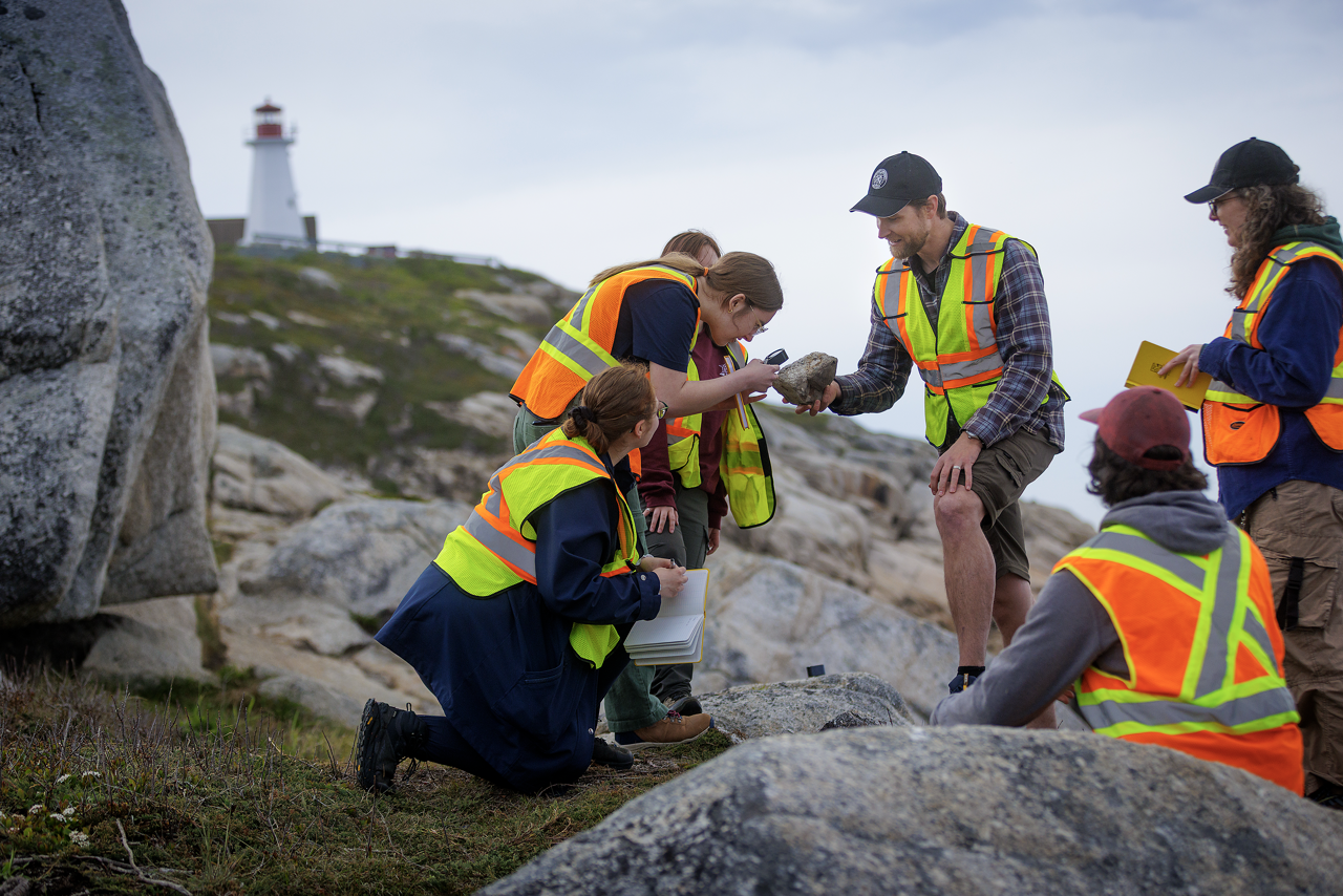 Geology students at field study looking at rocks