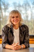 A photographic portrait of Dr. Martine Béland with a window in the background
